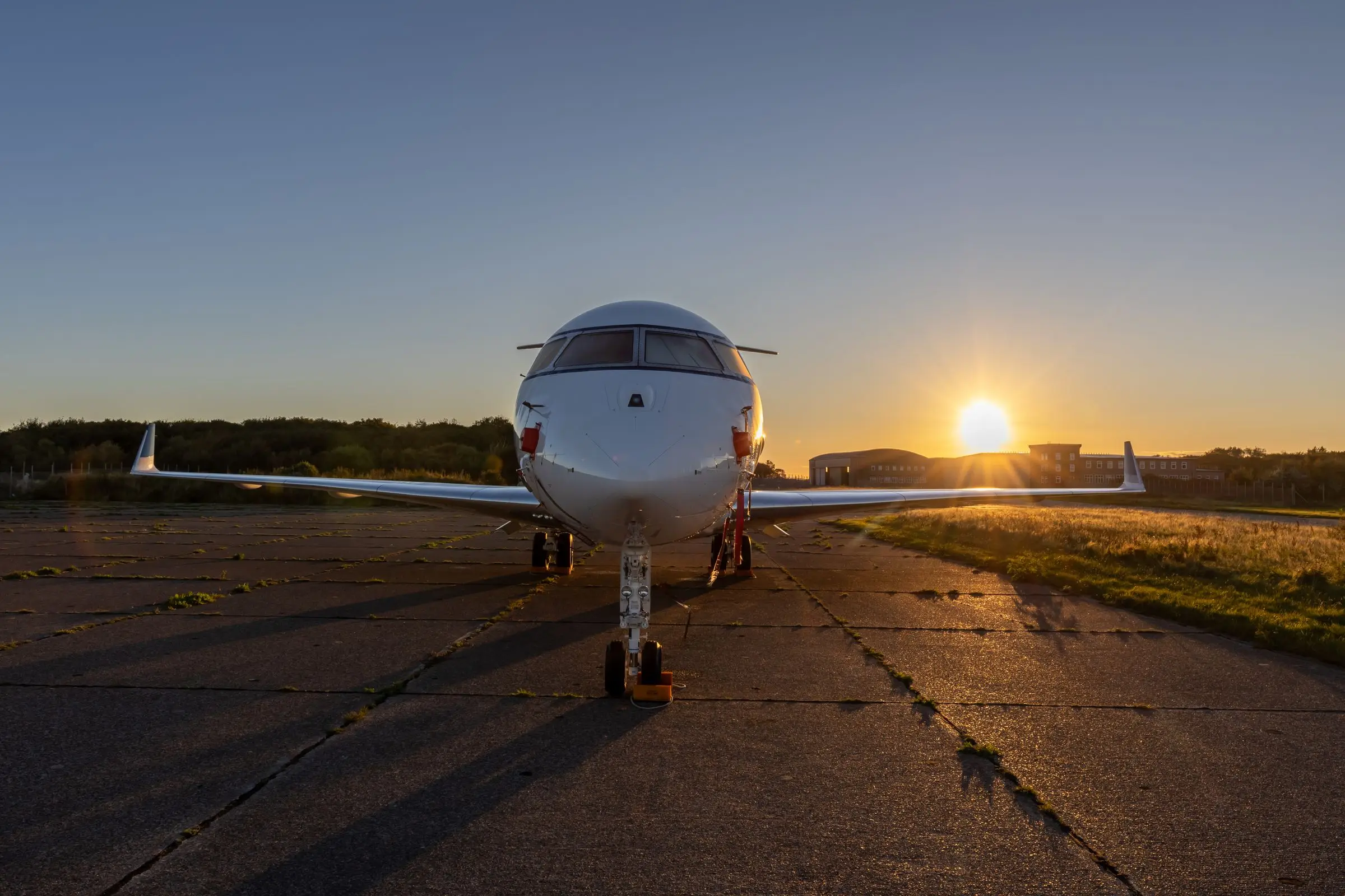 Private jet on a runway at sunset